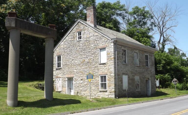 west gate tollhouse and marker